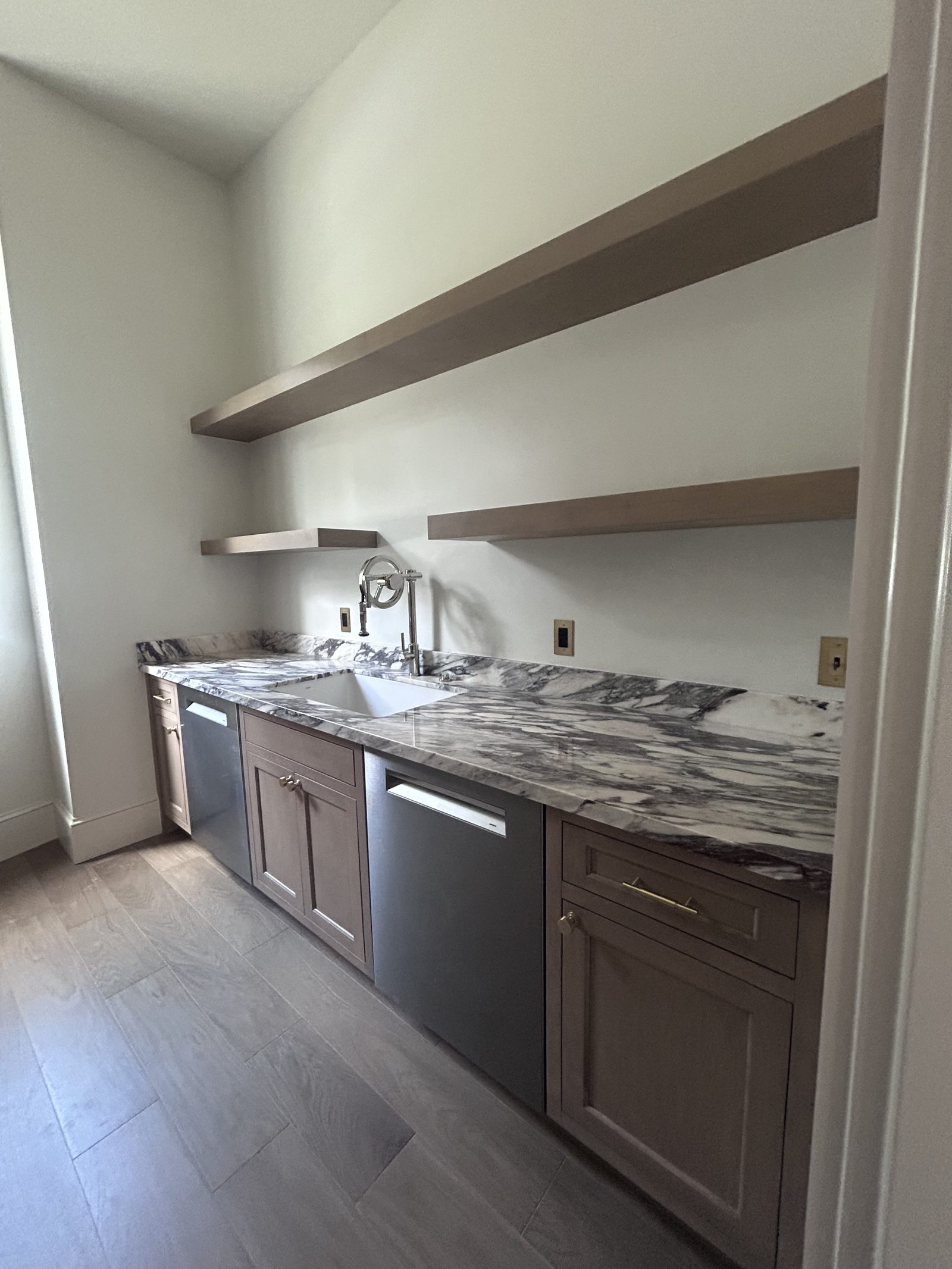 Marble butler pantry with floating shelves