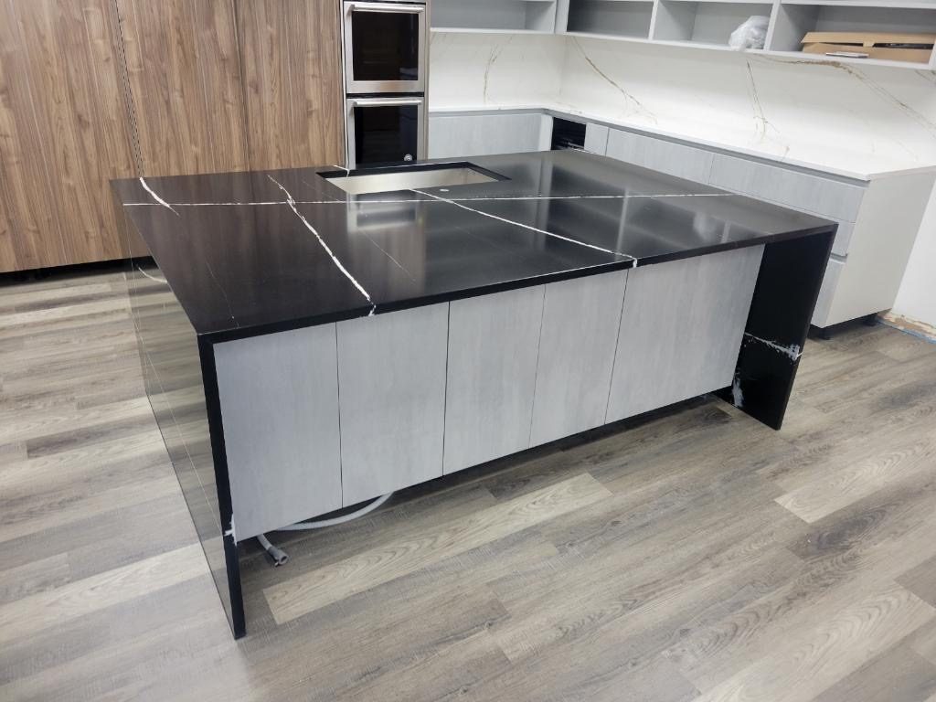 White quartz countertops with sage green shaker cabinets