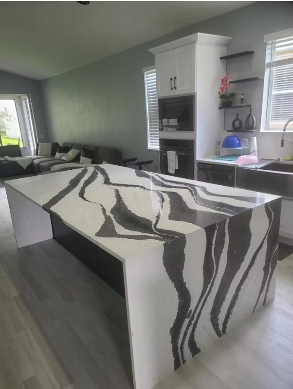 Black and white waterfall quartz kitchen island